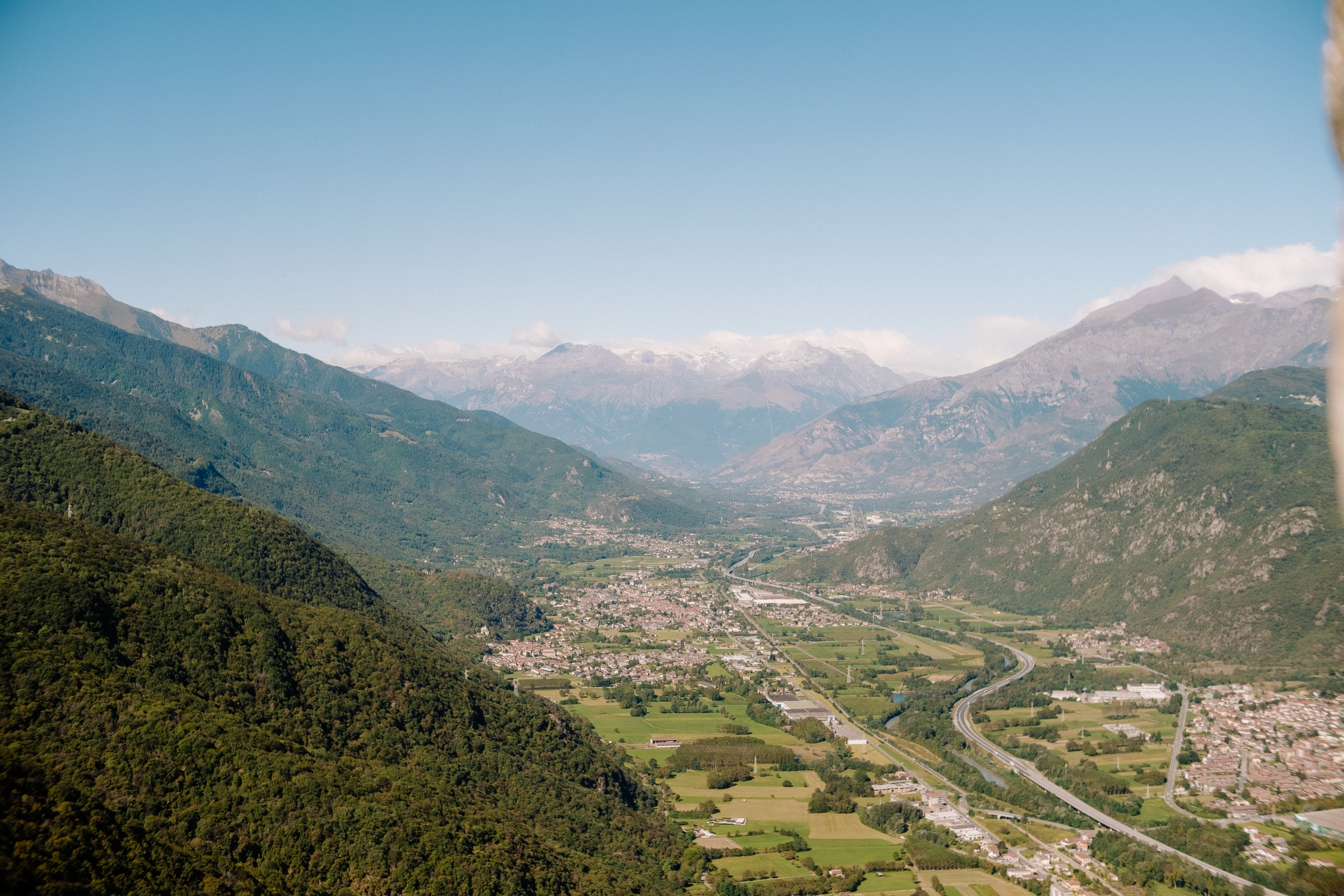 Aerial view of an alpine valley with a European village below